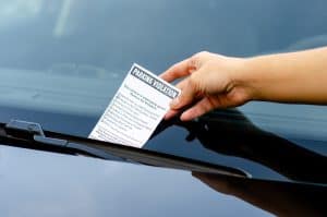 Parking ticket being left on an illegally parked car